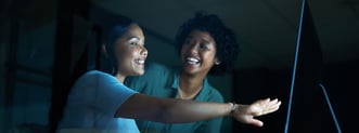 Two women discussing healthcare website design 